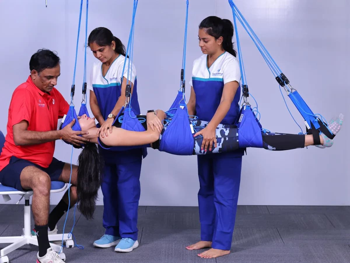 DakshinRehab physiotherapist guiding a patient through Levitas Neurac suspension therapy in Moosapet