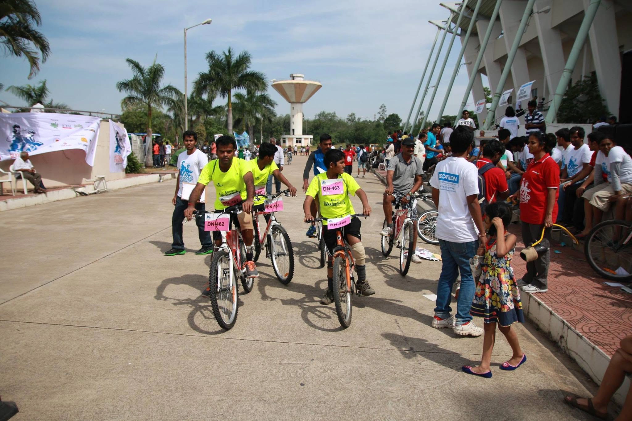 Amputee cyclists with prostheses riding bicycles at a DakshinRehab community cycling event