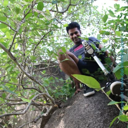 DakshinRehab patient with a leg prosthesis climbing rocks on an outdoor trek
