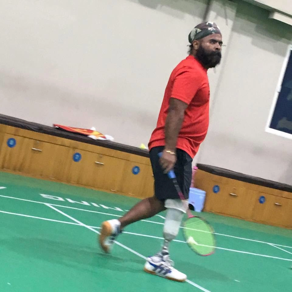 DakshinRehab patient playing racket sport indoors with a leg prosthesis