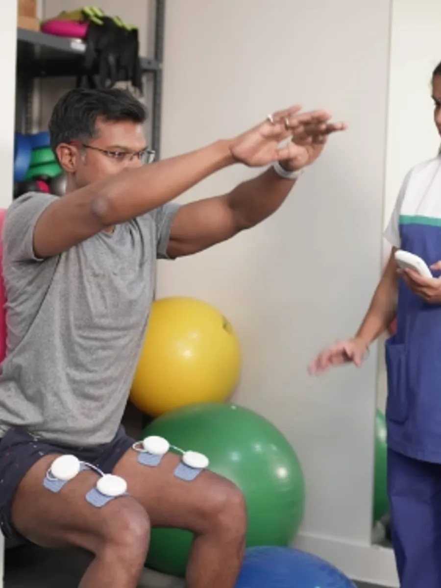 Patient viewing EMG biofeedback during quadriceps activation training