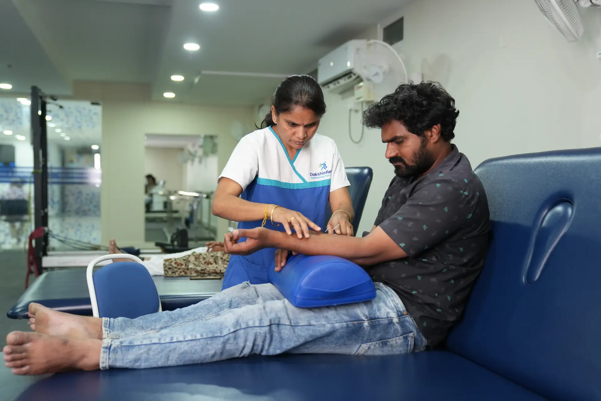 Physiotherapist performing dry needling on myofascial trigger point