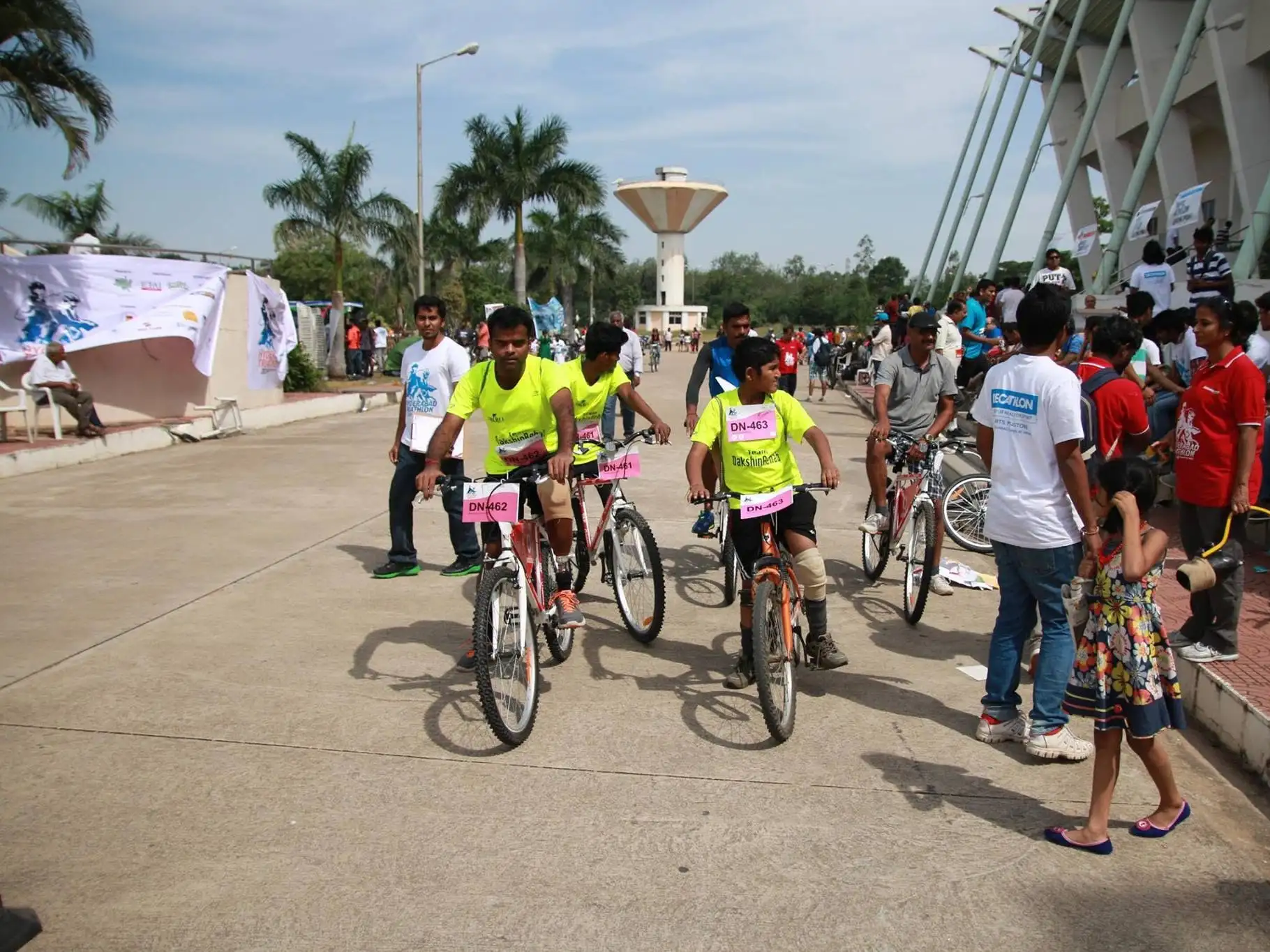 Amputee cyclists with prostheses riding bicycles at a DakshinRehab community cycling event