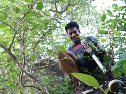 DakshinRehab patient with a leg prosthesis climbing rocks on an outdoor trek