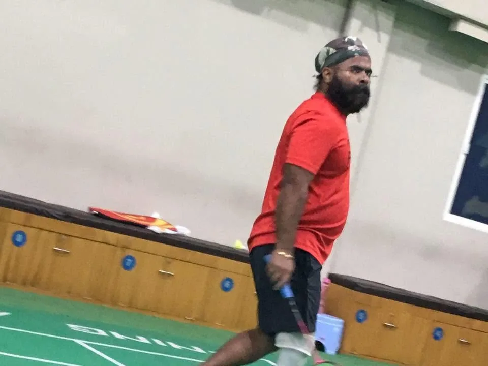 DakshinRehab patient playing racket sport indoors with a leg prosthesis