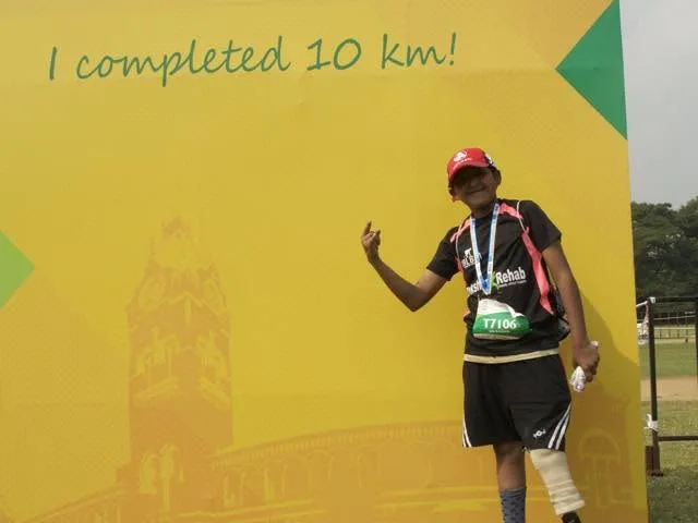 DakshinRehab patient with a running-blade prosthesis at a Chennai marathon 10K finish, Hyderabad