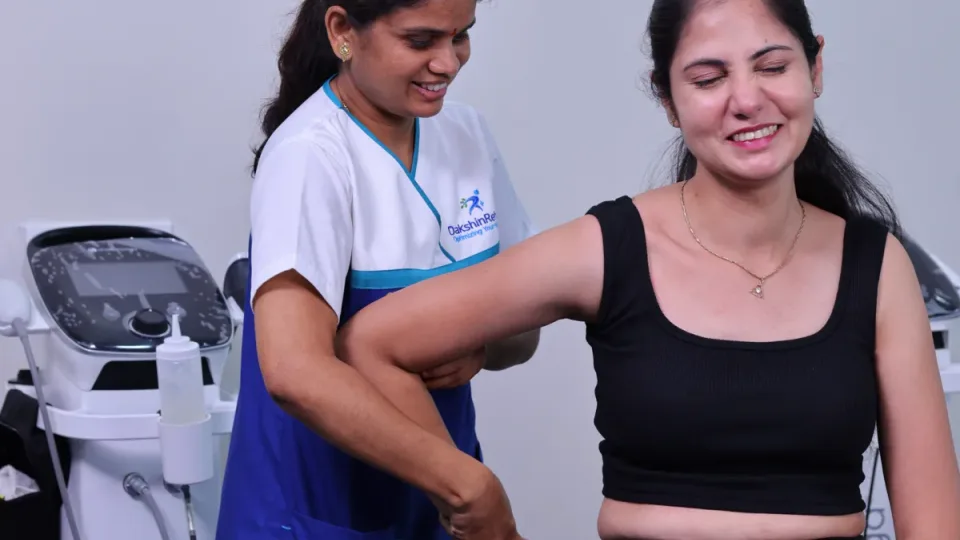 DakshinRehab physiotherapist measuring shoulder range of motion during a frozen shoulder assessment